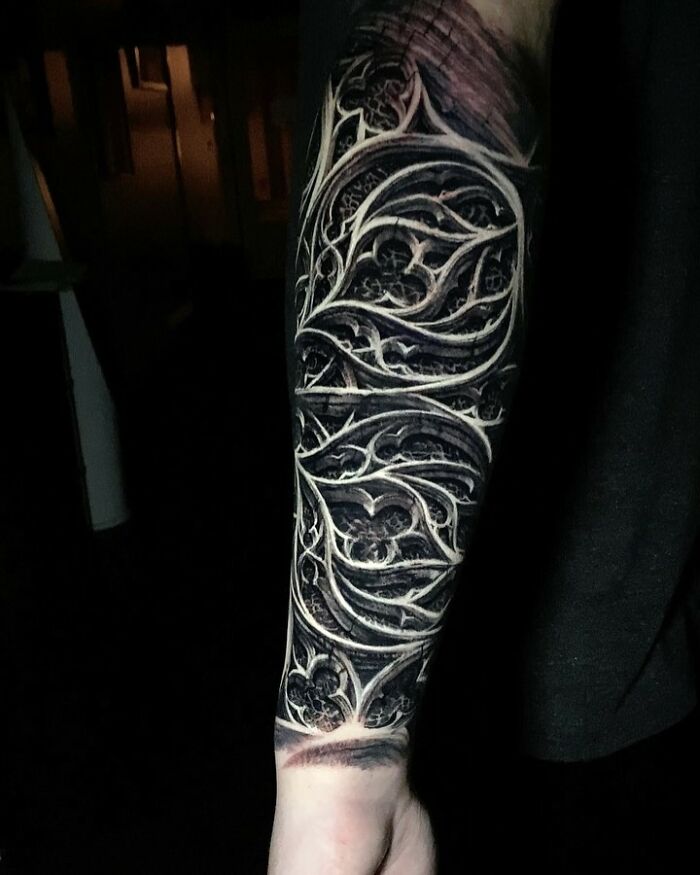 Intricate tattoo art featuring detailed dark and light patterns on a forearm, showcasing advanced tattoo techniques.