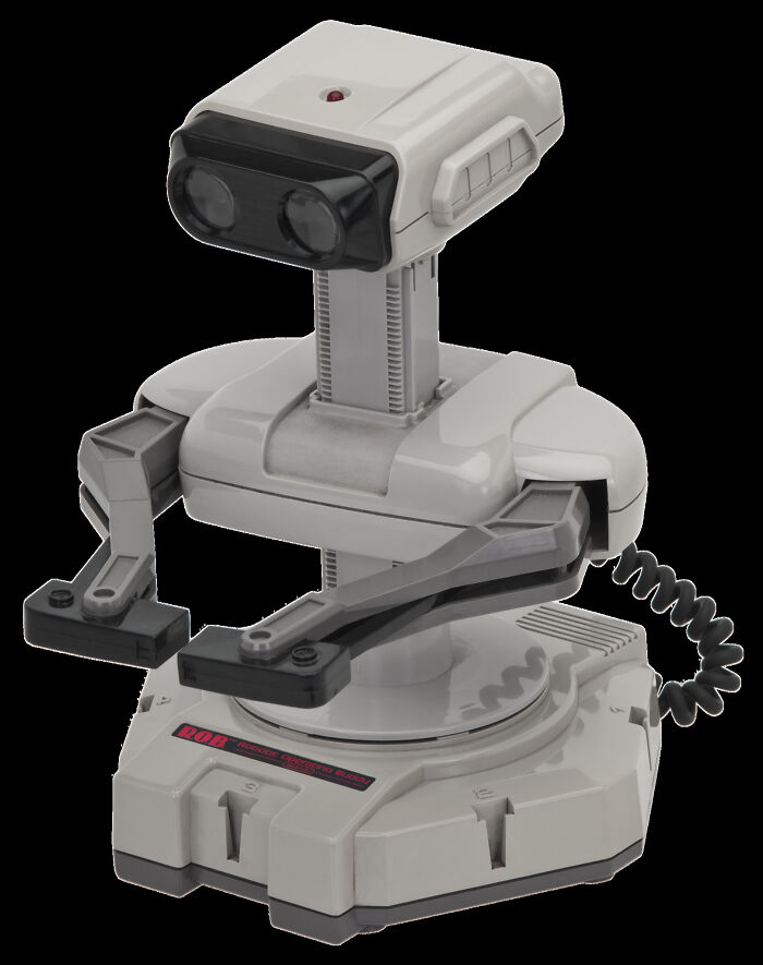 Retro robot toy with articulated arms and binocular-style eyes, a classic old gadget popular in vintage electronics collections.