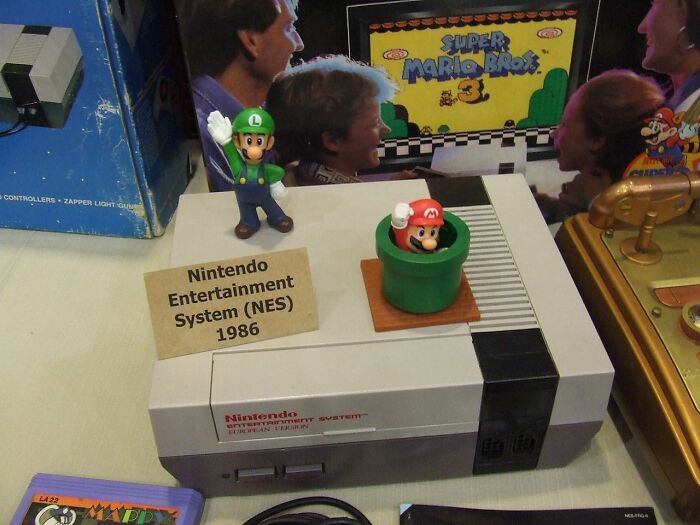 Nintendo Entertainment System with Mario and Luigi figures, showcasing one of the old gadgets that were trendsetters in technology.