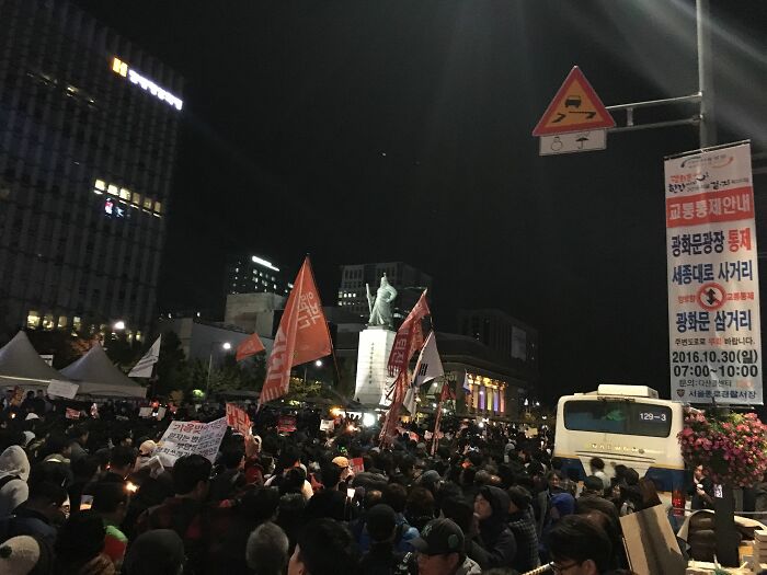 Multiple people with protest signs in the street 