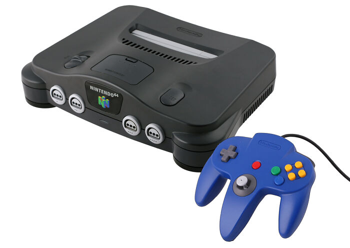 Retro black Nintendo 64 gaming console with blue controller, a classic old gadget and trendsetter of its time.