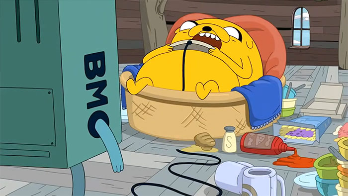 Jake the dog sleeping in his basket surrounded by a cluttered room, featuring Adventure Time quotes themes.