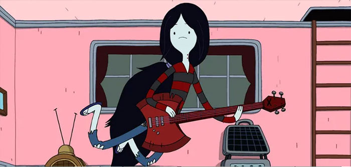 Marceline the Vampire Queen from Adventure Time playing a red guitar in a pink room with retro electronics nearby.