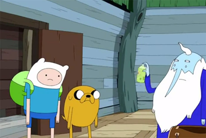 Ice King holding spray in front of Finn and Jake in a scene from Adventure Time with wacky quotes.