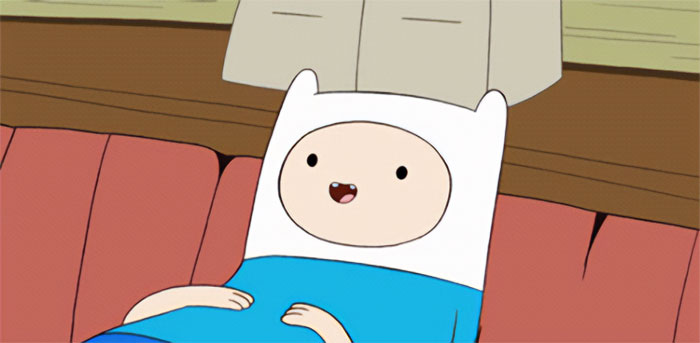 Finn the Human lying and smiling on a bed, representing quirky and wacky Adventure Time quotes with a profound vibe.