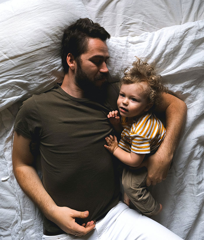 Man and Son Lying in Bed