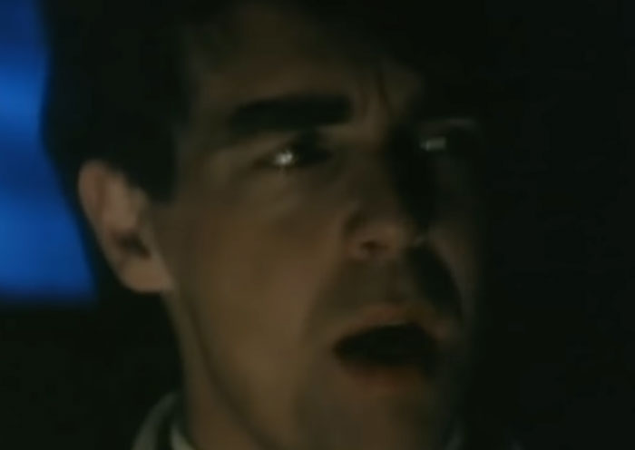 Man sitting in a car and singing 