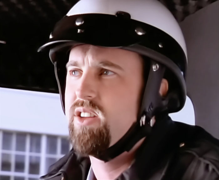 Man sitting with a helmet and talking 