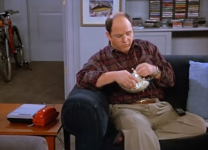 Man sitting and eating popcorn 