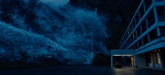 Huge wave is about to cover a building 