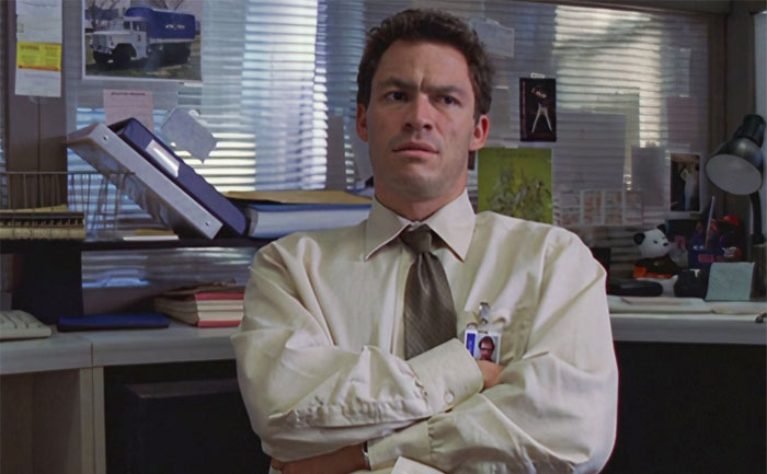 Confused man sitting with his hands crossed 