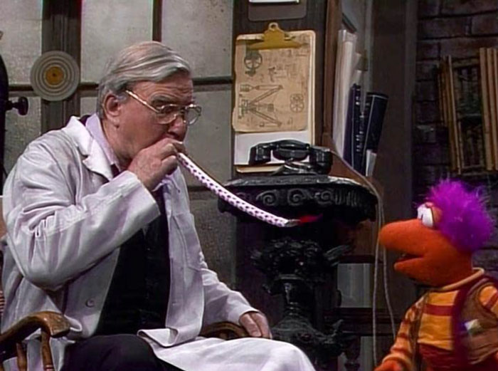 Man and a puppet smoking something 