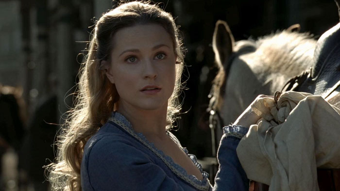 Woman preparing to ride a horse 