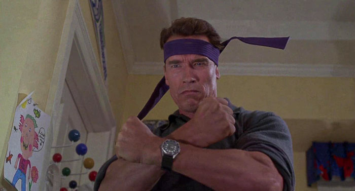 Howard Langston wearing belt on his head from Jingle All the Way