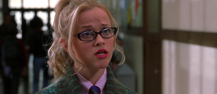 Elle wearing glasses and red lipstick 