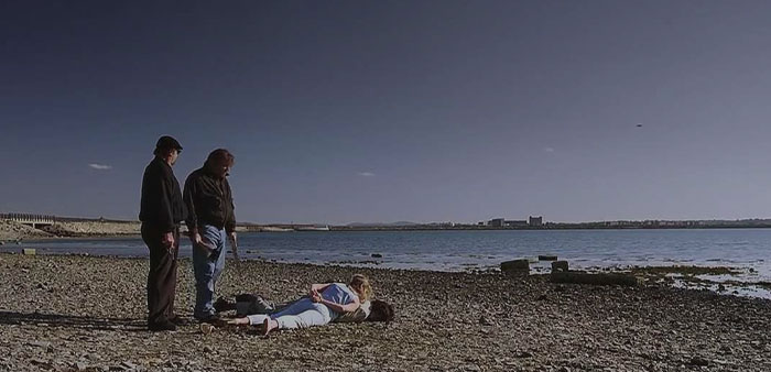 Two men and a woman on the beach 