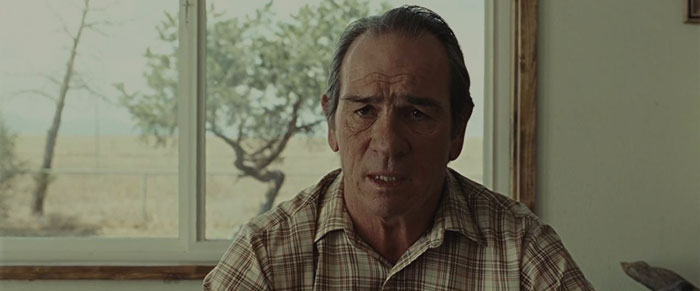 Ed Tom Bell wearing a striped shirt 