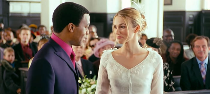Scene from Love Actually movie featuring a couple during a wedding, perfect for best wedding movies SEO.