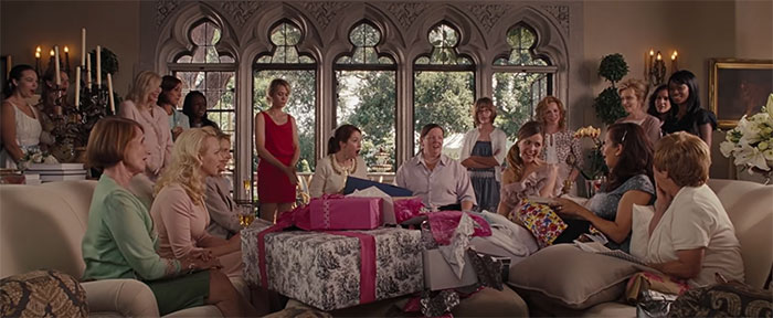 Scene from Bridesmaids celebrating love with gifts and laughter, a highlight among the best wedding movies ever made.