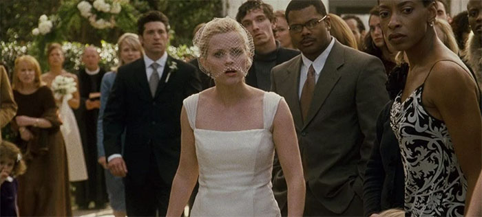 Scene from Sweet Home Alabama wedding movie featuring bride in white dress surrounded by guests celebrating love and marriage.