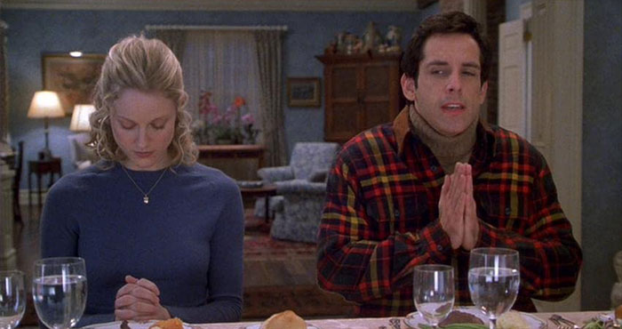 Scene from Meet The Parents movie showing a couple at dinner, highlighting the best wedding movies celebration of love.