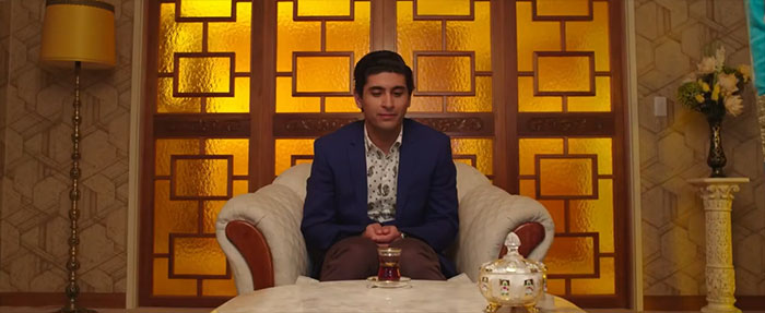 Scene from Ali's Wedding movie showing a man in a blue jacket, highlighting best wedding movies celebrating love.