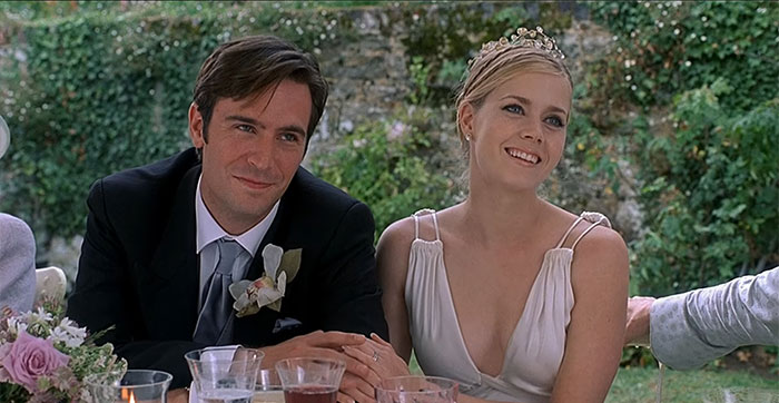 Scene from The Wedding Date with a couple dressed for a wedding, celebrating love in a romantic movie moment.