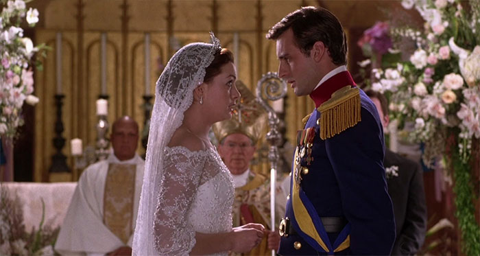 Bride and groom facing each other in a royal wedding scene from one of the best wedding movies celebrating love.