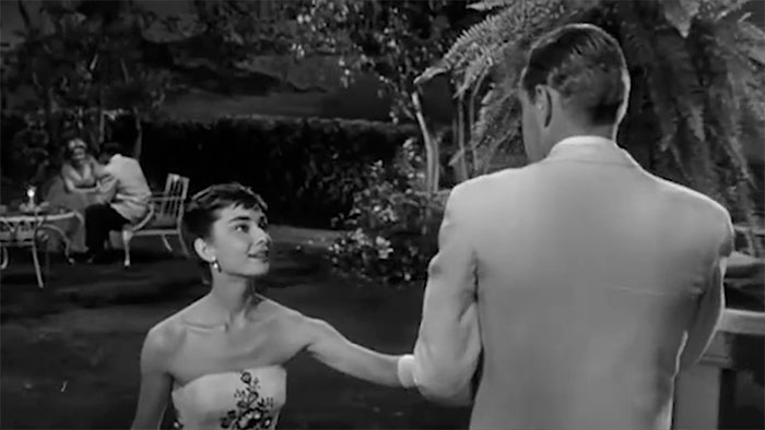 Scene from Sabrina movie featuring romantic moment, perfect example of wedding movies celebrating love.