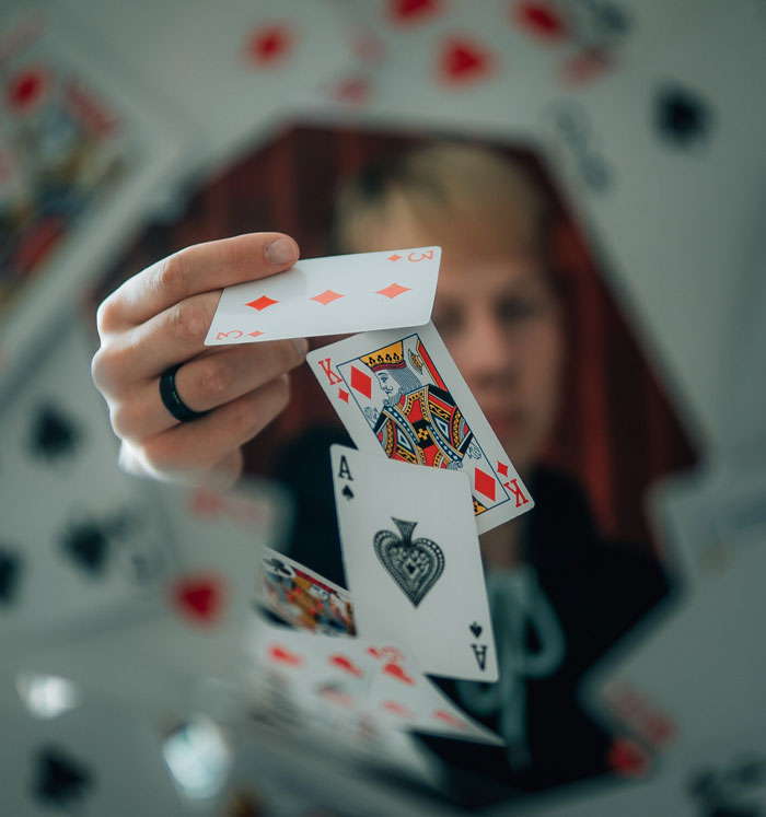 Person throwing multiple cards from the top 