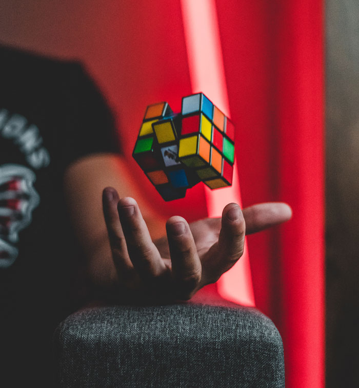 Person throwing a Rubik's cube into the air 