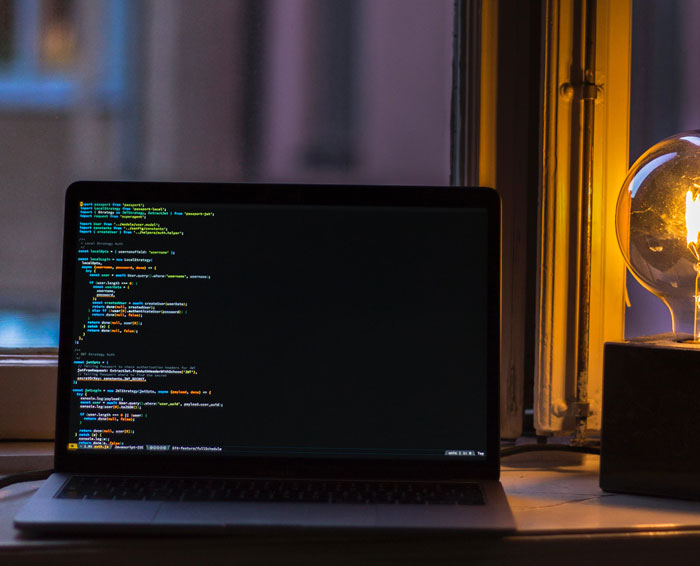 Computer with programing codes on the screen in the room 