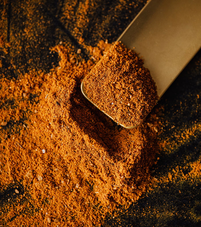 Smoked paprika seasoning on black background