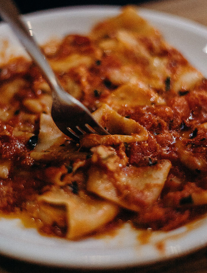 Stainless steel fork on white ceramic plate