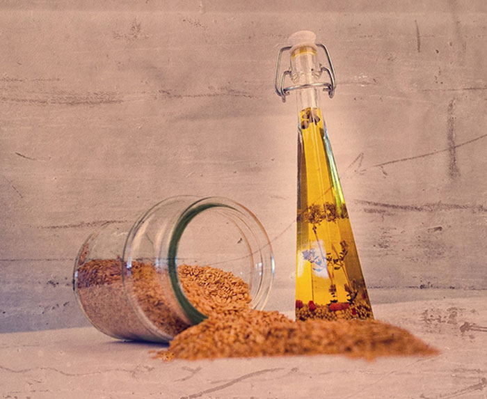 Glass of sesame oil and bottle of the sesame oil