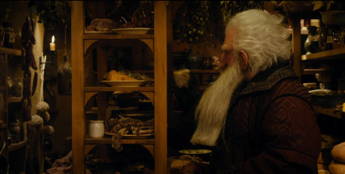 the man near the shelves with plates