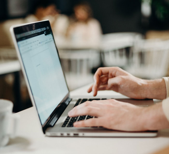 person typing something on the laptop