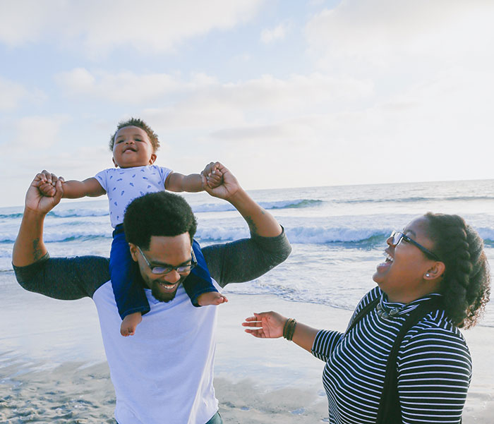 Family at the beach laughing