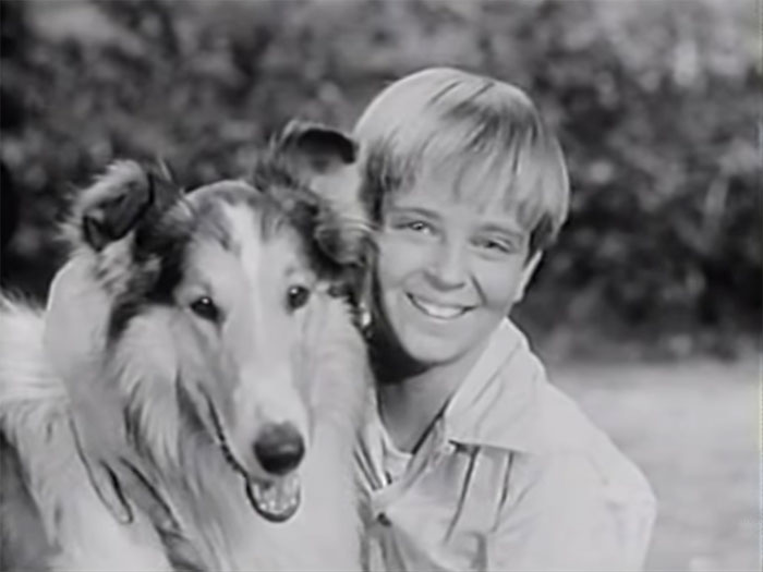 Tommy Rettig hugging a dog 