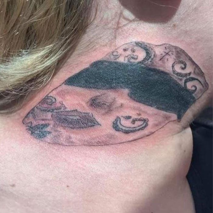 Abstract and blurry face tattoo on neck representing one of the epic tattoo fails shared by folks online.