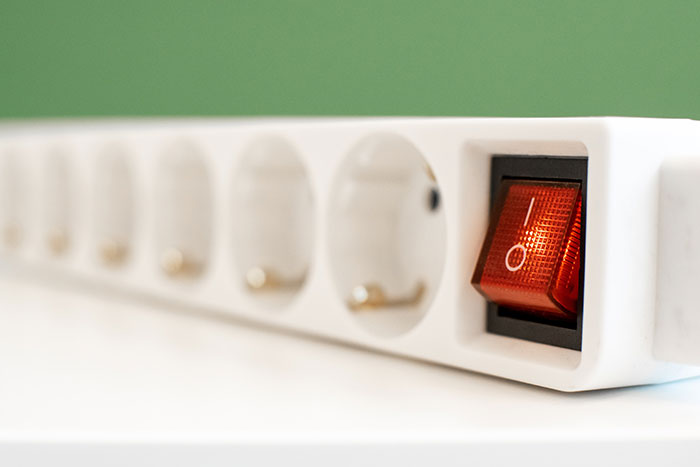 A close up of a red light on a white device