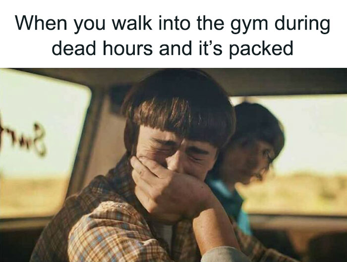 Person in disbelief, reacting to a crowded gym during supposed dead hours.