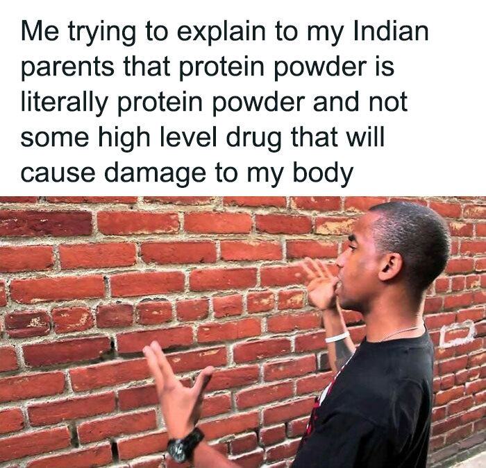 Person frustratedly explaining protein powder to a brick wall, humorously representing gym rats' relatable struggles.