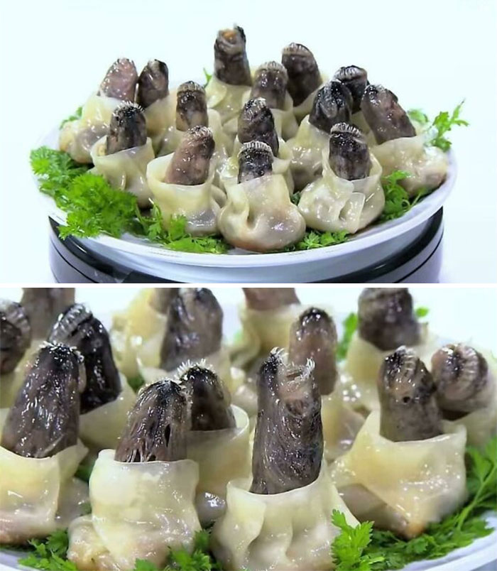 Unappetizing food with dark, finger-like pieces in dumplings, garnished with greens on a white plate.