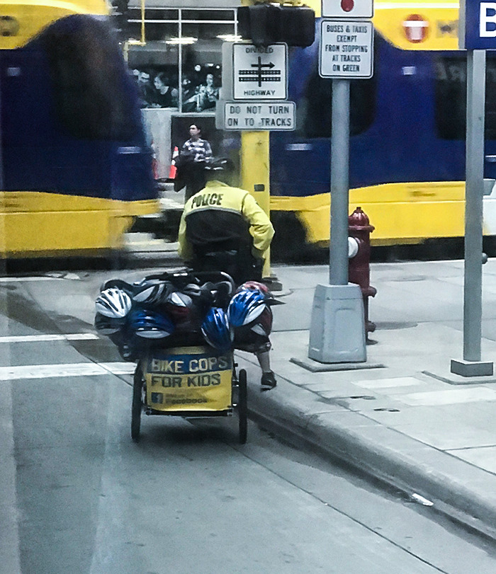 Bike Police In Downtown Minneapolis Travel With Tons Of Helmets To Give Away To Bikers Without One
