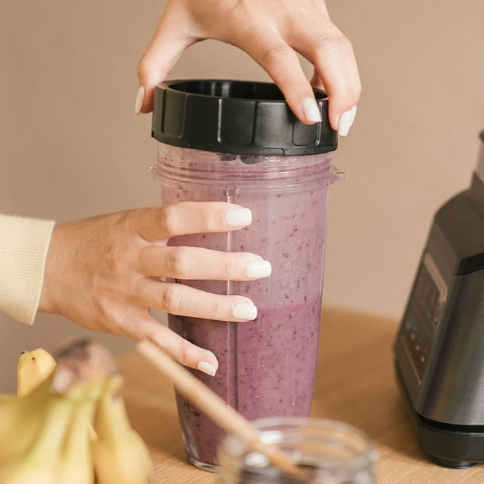 Woman holding a blender