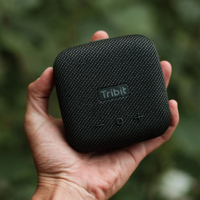 Human holding Bluetooth speaker