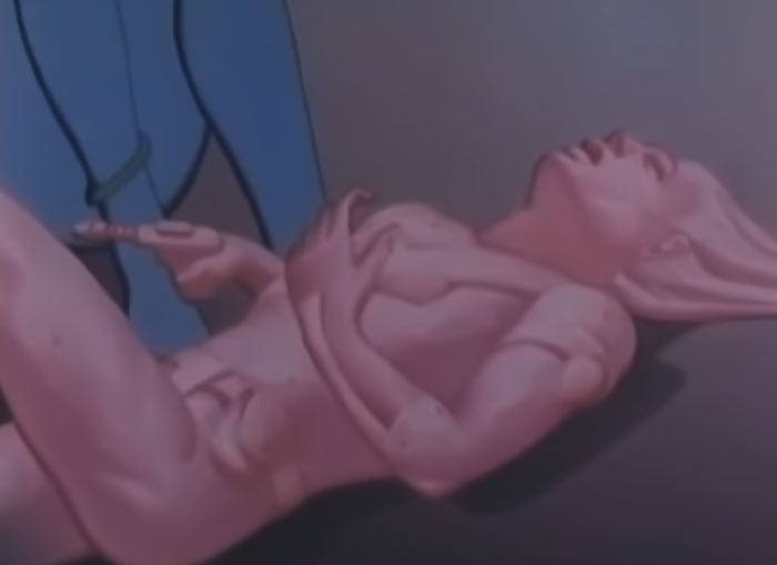 Image from Mystery Skulls "Be With You" & "Invincible" music video - a pink cyber woman with an open mouth and gun in her hands lying down