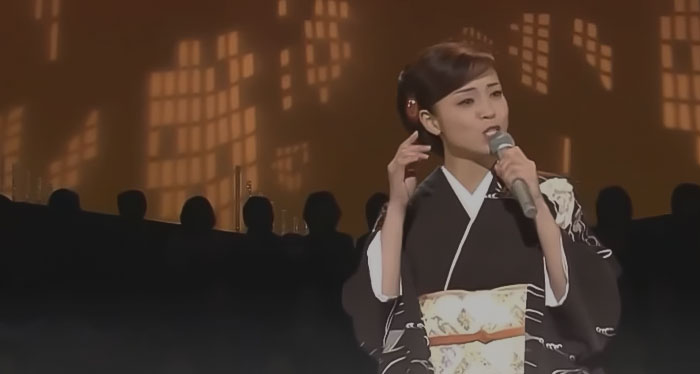 A Japanese girl in a kimono is singing