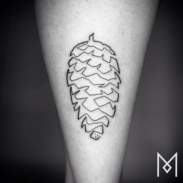 Single line tattoo of a pinecone on a person's leg.